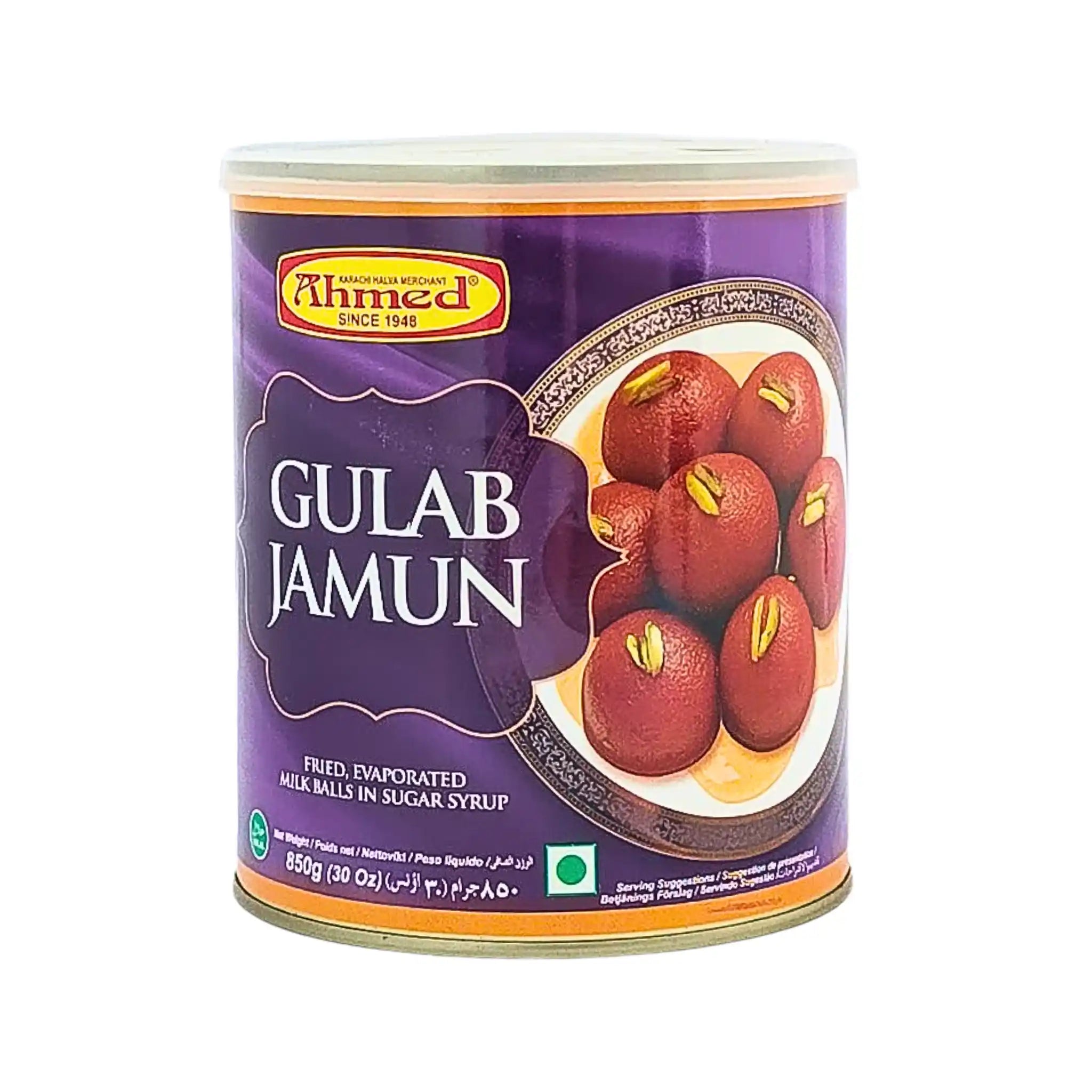 Purkki 850 g Gulab Jamunia sokerisiirapissa, intialainen jälkiruoka pistaasipähkinöillä violetilla taustalla