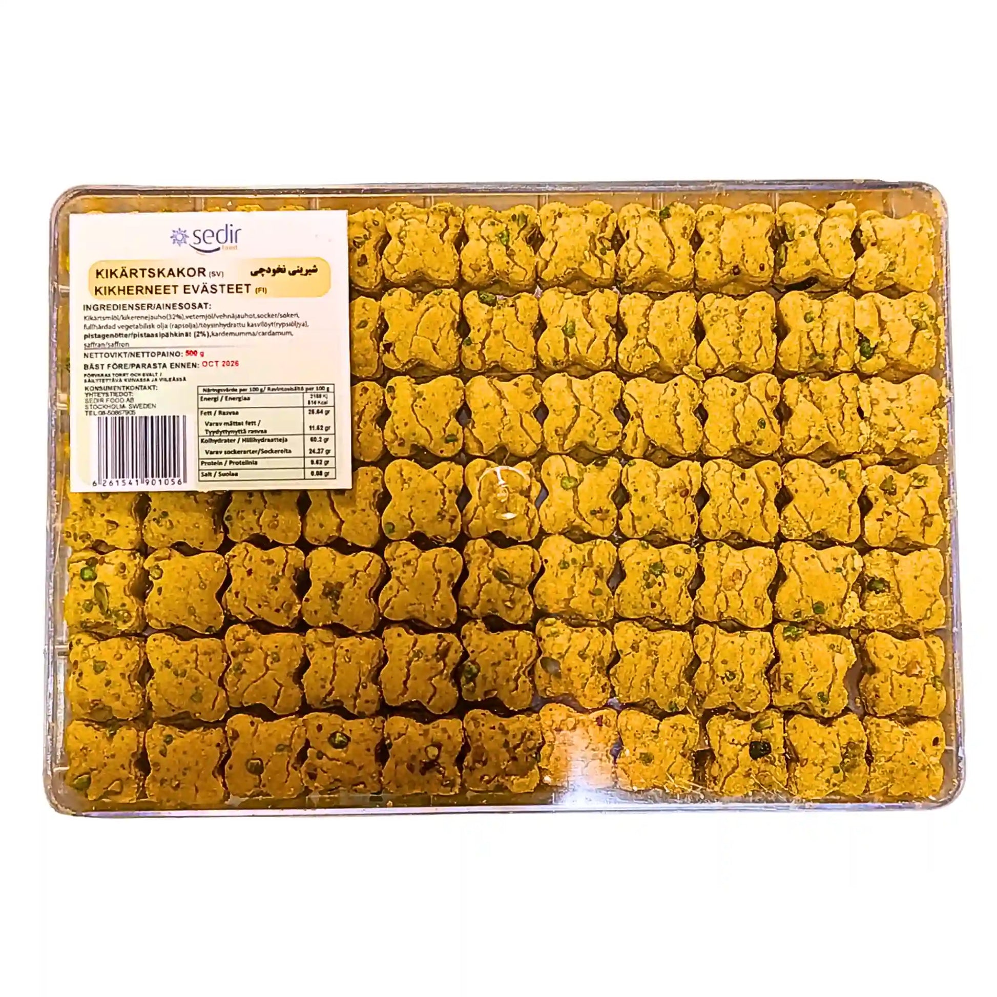 Valmiiksi pakattuja kikhernekakkuja muoviastiassa, 500 g, itämaista leivonnaista, jossa näkyviä yrttejä.