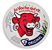 Pyöreä purkki La Vache qui rit -mehustettua juustoa, punainen lehmä, teksti useilla kielillä, kukkamotiivi.